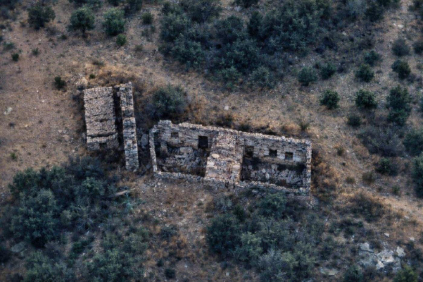 Remaining stone wall from the Palaiokatouno family home burned during the Occupation